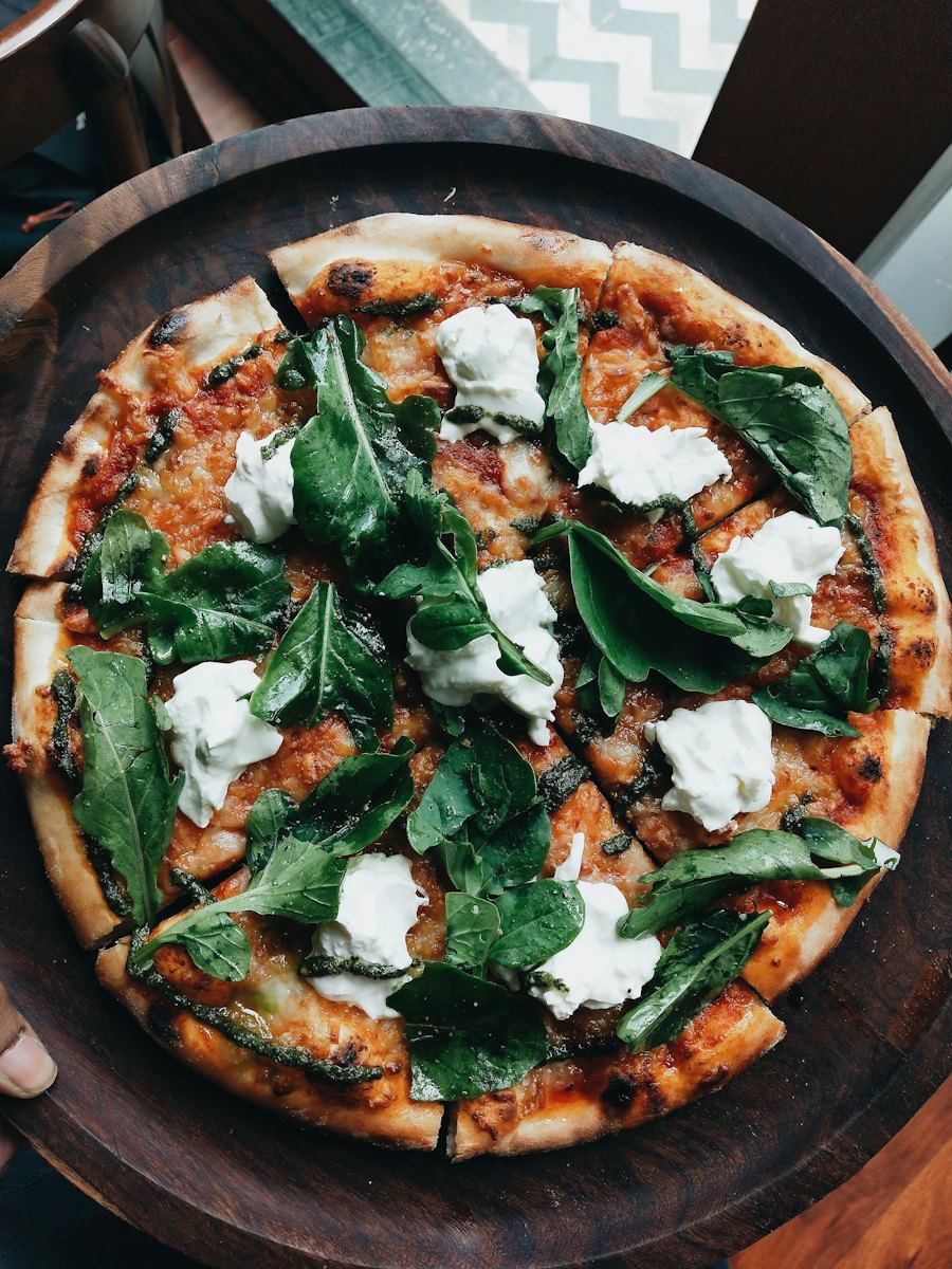 A white pizza finished with pesto